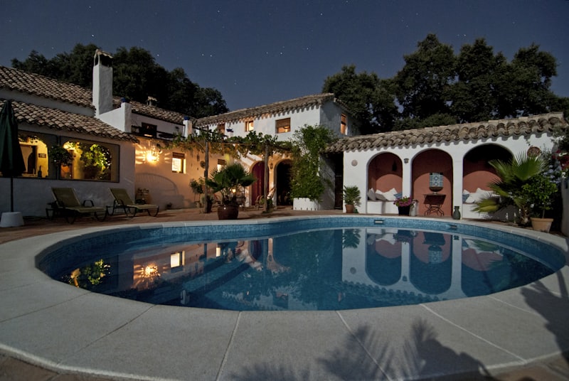 Mediterranean villa with private pool and terrace lit at dusk