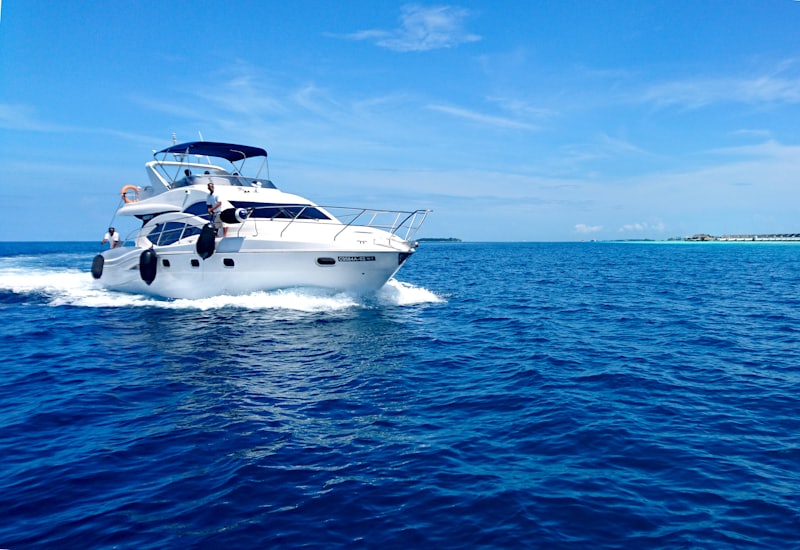 White yacht anchored in clear turquoise bay water